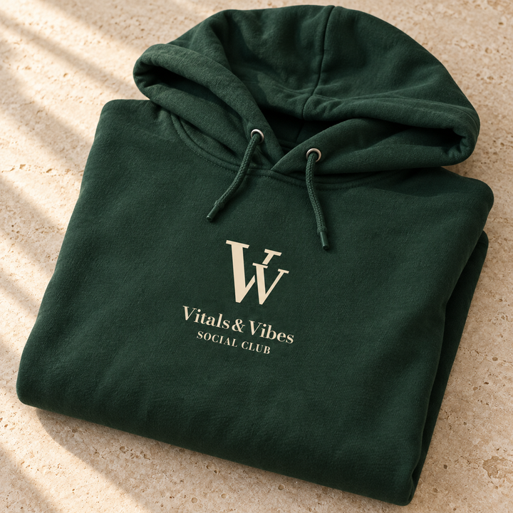 Social Club hoodie in Dark Green, folded for a close detail view, showing the VV, Vitals & Vibes and Social Club chest print.