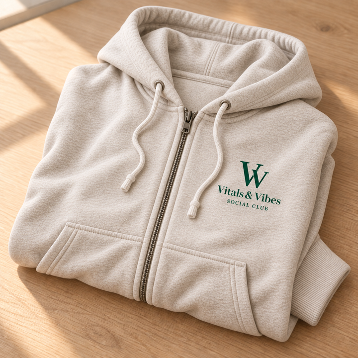 Full-zip hoodie in Oatmeal Heather, folded for a close detail view, showing the design and garment details.