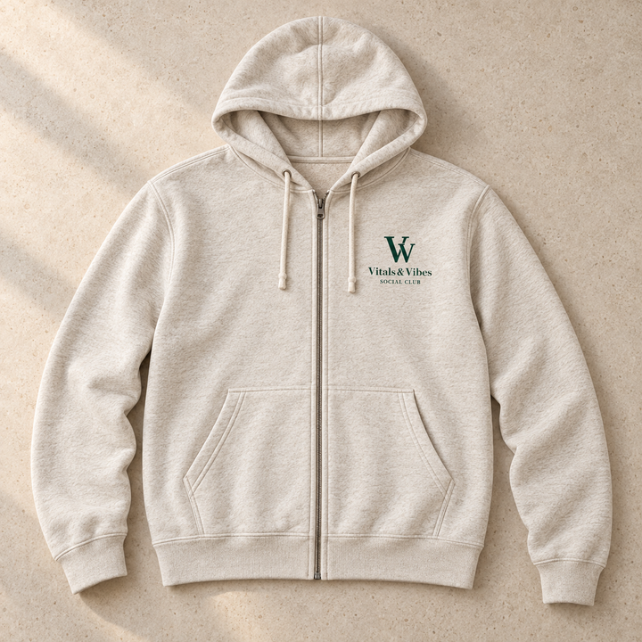 Full-zip hoodie in Oatmeal Heather, laid out on a table, showing the design and garment details.