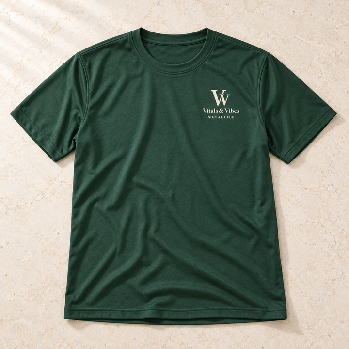 Planned design preview: full garment laid flat of forest green performance tee with cream VV, Vitals & Vibes and Social Club chest print