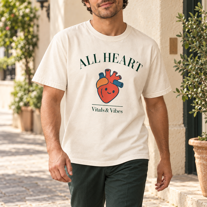 Man walking past a cream stucco street corner in an ivory All Heart tee and dark green trousers.