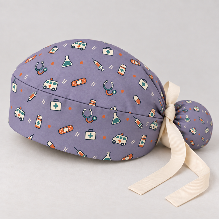 All Medicine ponytail scrub cap — studio mockup showing the printed cap and cream ties.