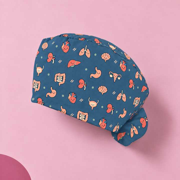 All Organs Ponytail Scrub Cap — Studio view of the printed cap on a coordinated background.
