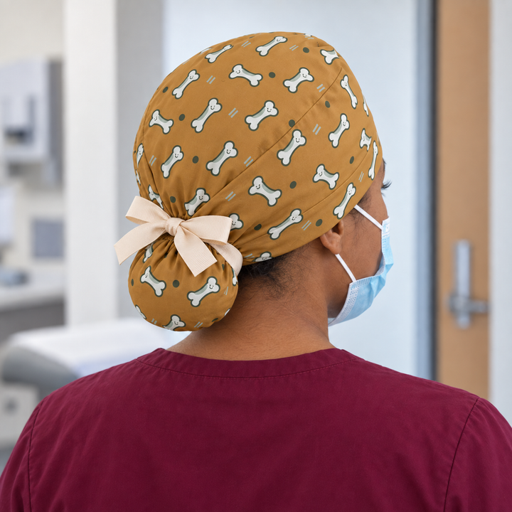 Bone Ponytail Scrub Cap — Rear worn view showing the printed ponytail pouch and cream ribbon bow.