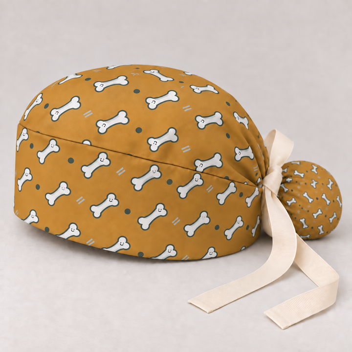 Bone ponytail scrub cap — studio mockup showing the printed cap and cream ties.