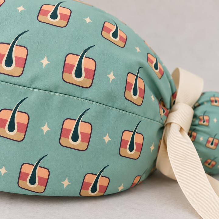 Derm ponytail scrub cap — close-up mockup showing the printed fabric and stitched seam.