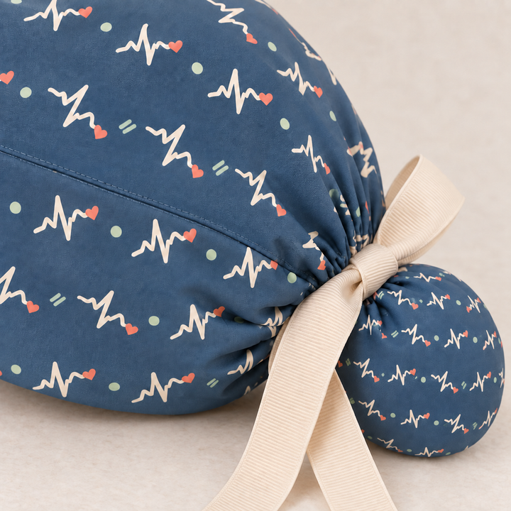 ECG ponytail scrub cap — close-up mockup showing the printed fabric and stitched seam.