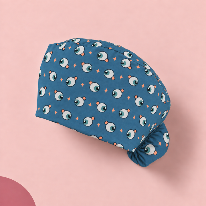 Eye Ponytail Scrub Cap — Studio view of the printed cap on a coordinated background.