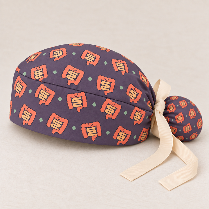 Intestine ponytail scrub cap — studio mockup showing the printed cap and cream ties.