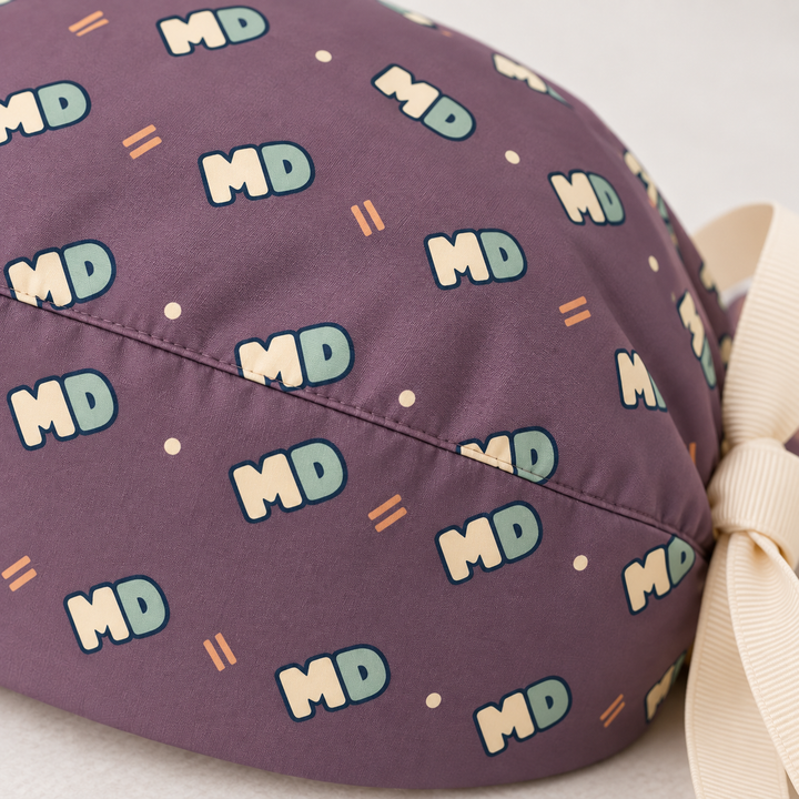 MD ponytail scrub cap — close-up mockup showing the printed fabric and stitched seam.