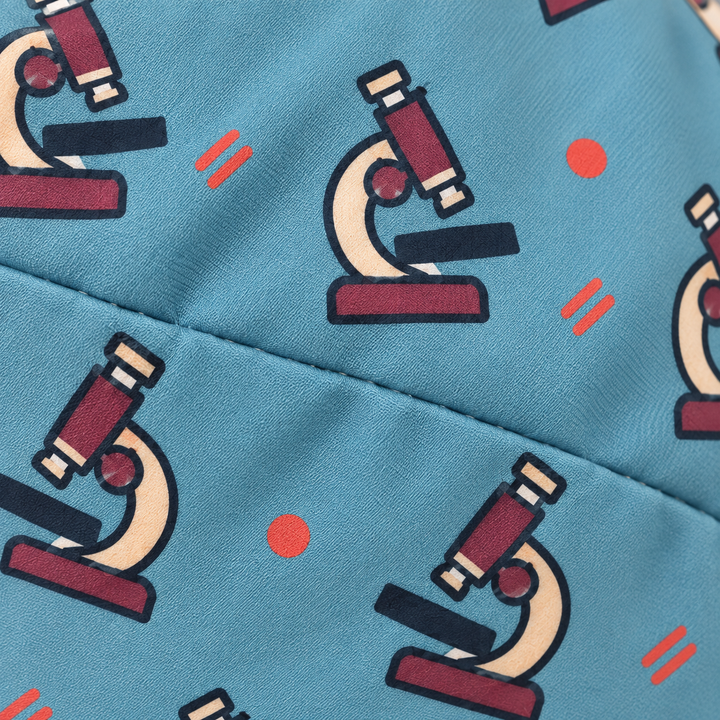 Microscope ponytail scrub cap — close-up mockup showing the printed fabric and stitched seam.