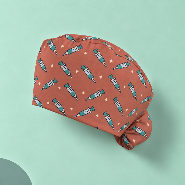 Needle Ponytail Scrub Cap — Studio view of the printed cap on a coordinated background.