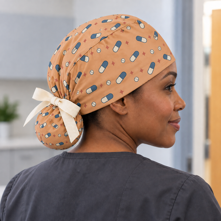 Pill ponytail scrub cap worn with plain scrubs in a clinical-setting mockup.