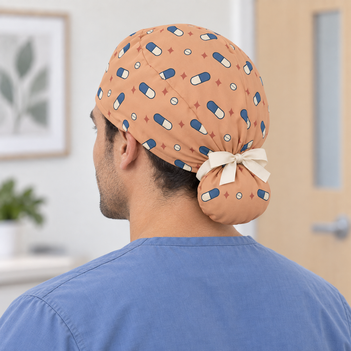 Pill Ponytail Scrub Cap — Rear worn view showing the printed ponytail pouch and cream ribbon bow.