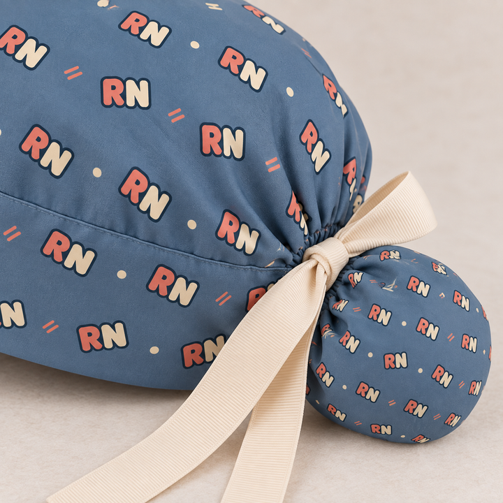 RN ponytail scrub cap — close-up mockup showing the printed fabric and stitched seam.