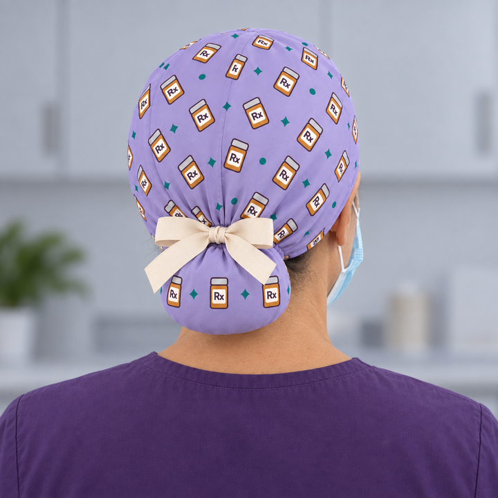 Rx Ponytail Scrub Cap — Rear worn view showing the printed ponytail pouch and cream ribbon bow.