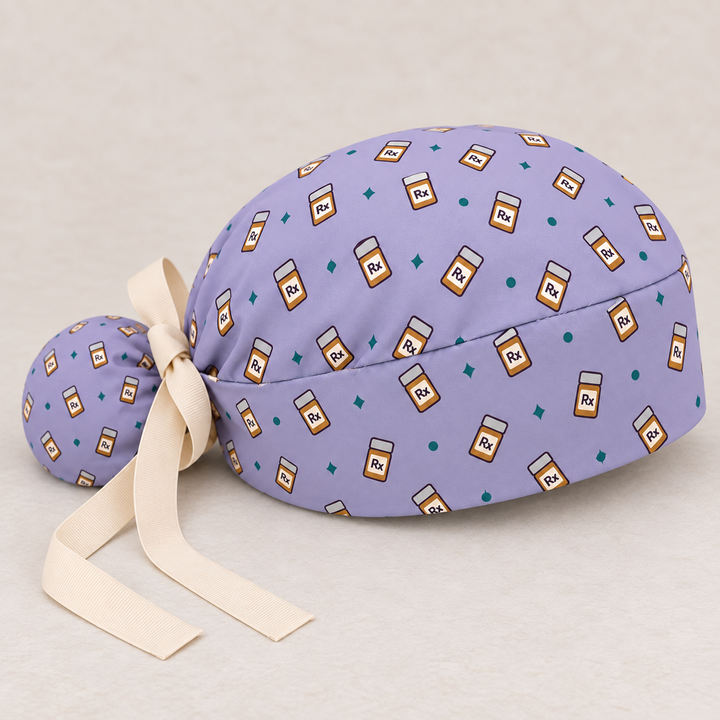 Rx ponytail scrub cap — studio mockup showing the printed cap and cream ties.