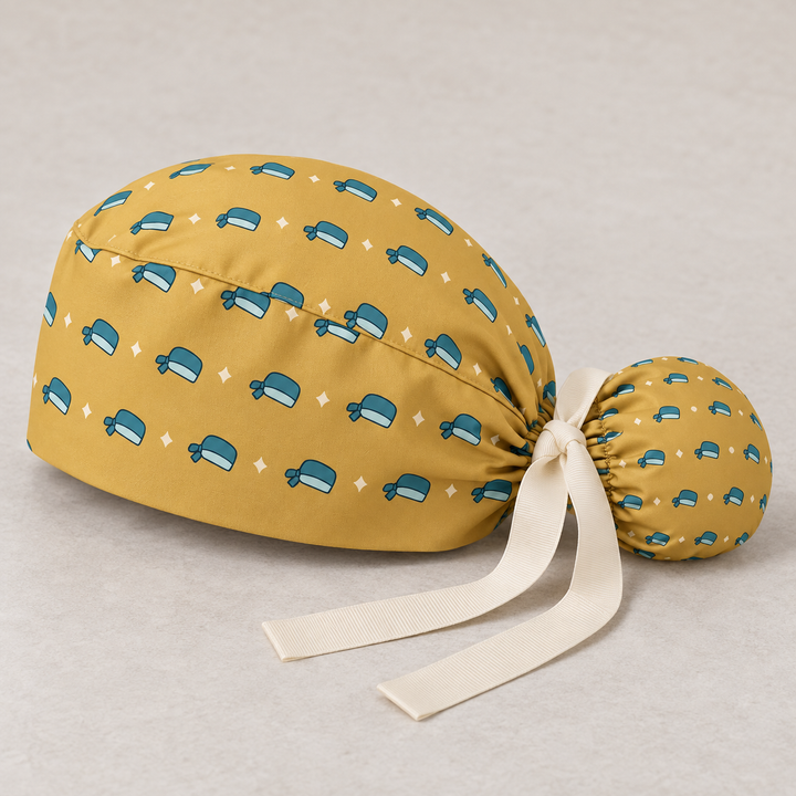 Surgical Cap ponytail scrub cap — studio mockup showing the printed cap and cream ties.