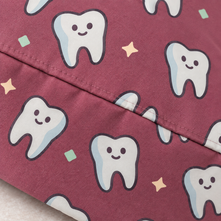 Tooth ponytail scrub cap — close-up mockup showing the printed fabric and stitched seam.