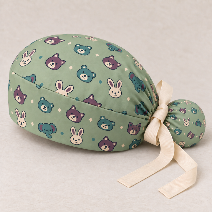 Veterinary ponytail scrub cap — studio mockup showing the printed cap and cream ties.
